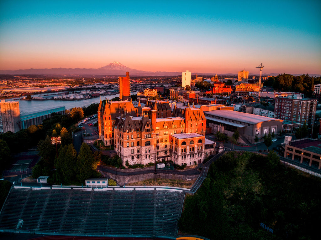 a view of the stadium district of tacoma in pierce county, wa at sunset with stadium high school in the foreground and mt rainier in the distance